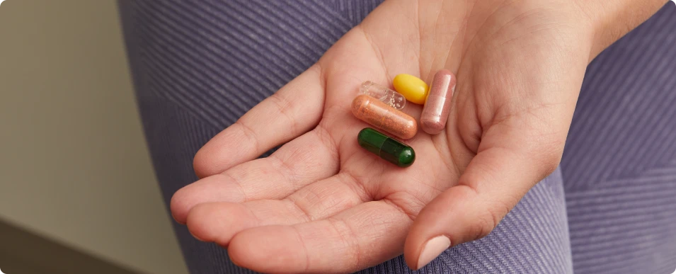 hands holding capsules